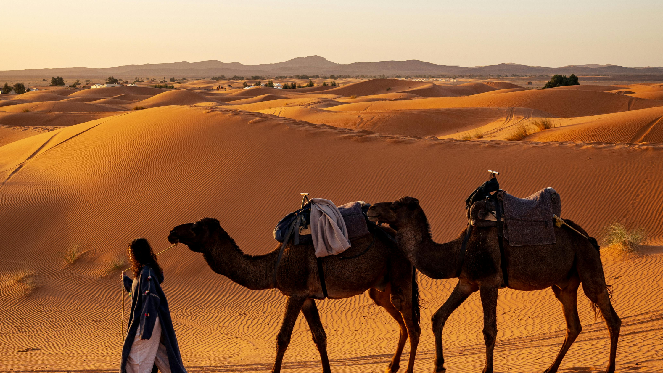 Woman enjoying sunset in Merzouga Desert